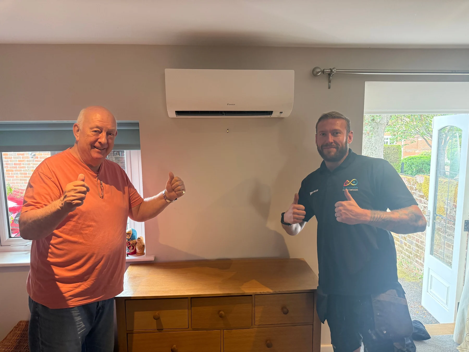 Satisfied customer with the Becketts engineer after a heating job