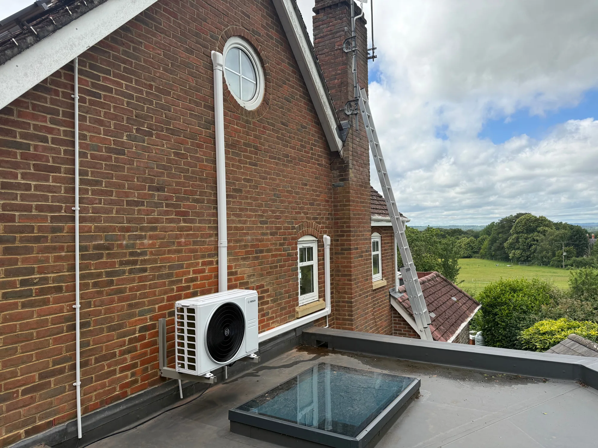 External air conditioning condenser unit with countryside view