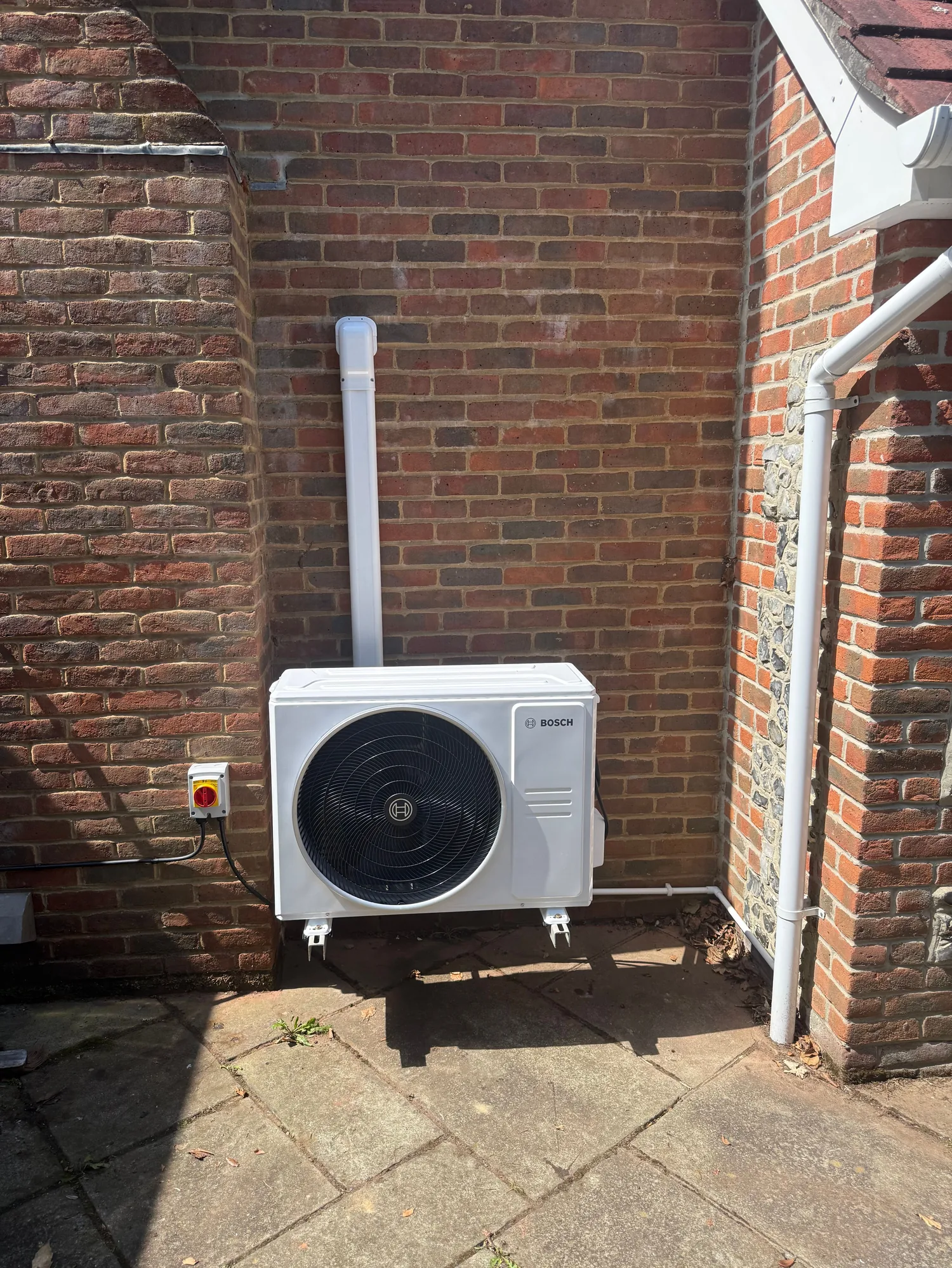 Neatly installed external air conditioning unit on a Hampshire home