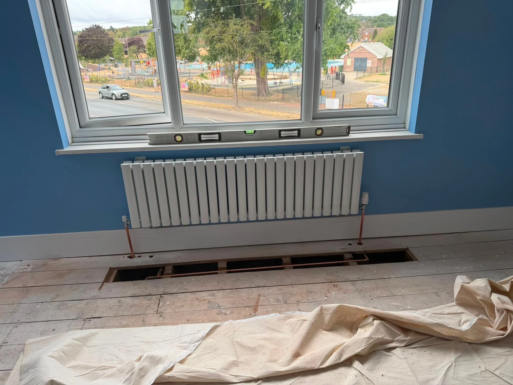 New radiator installed during a heating upgrade in Hampshire